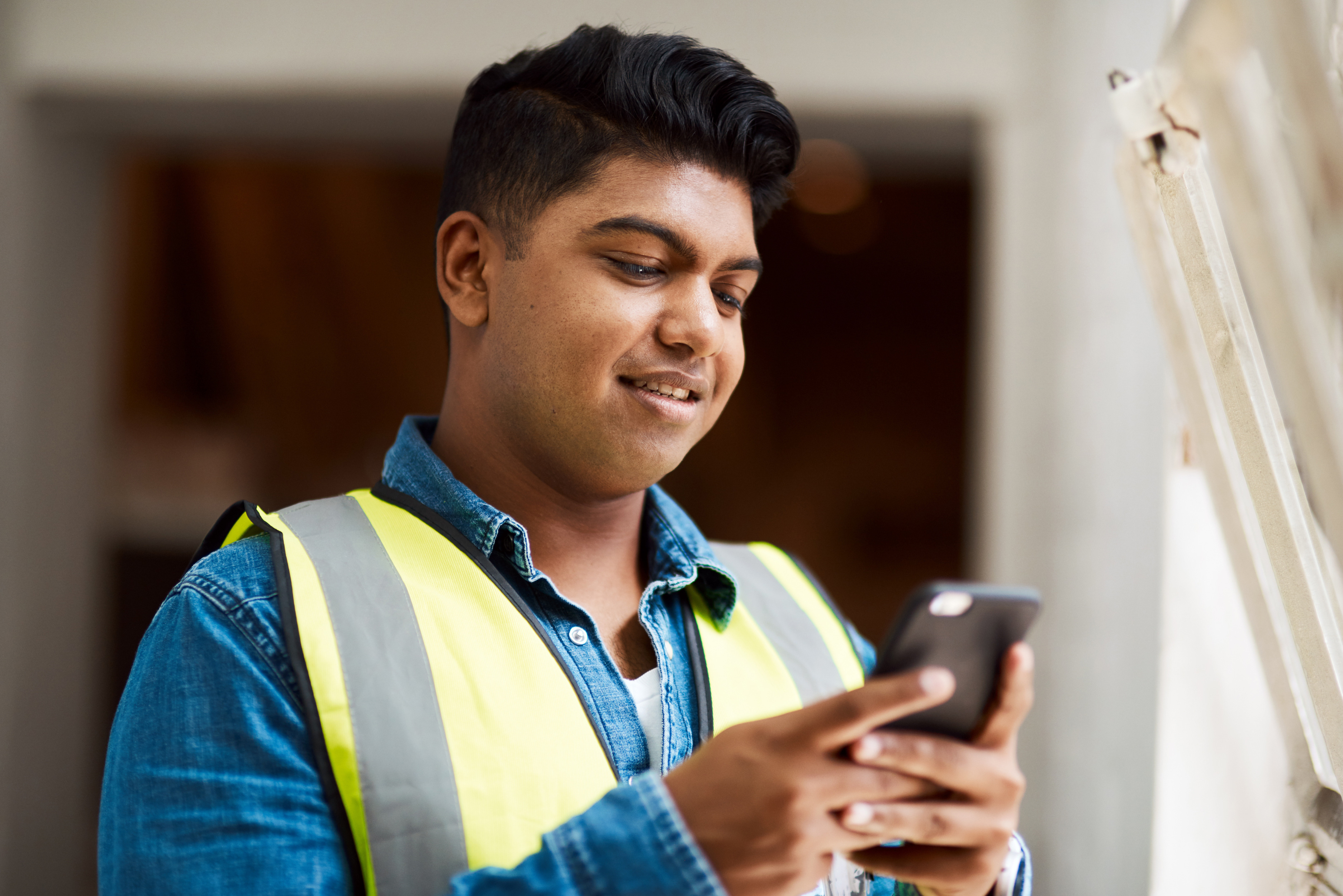 Man architect typing with phone construction project communication development engineer inspector building site management text maintenance infrastructure renovation