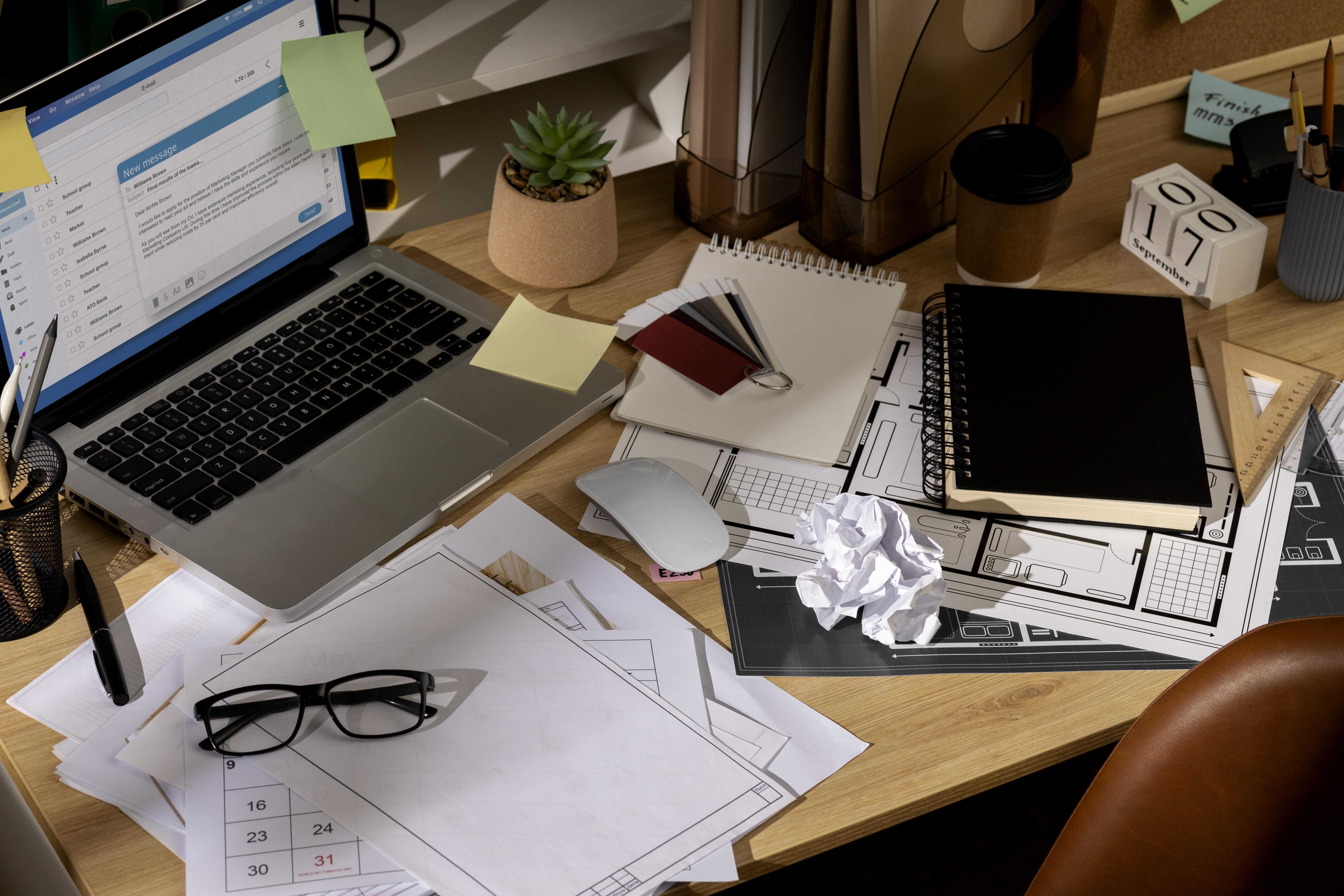 View office desk with messy workspace laptop 1 min